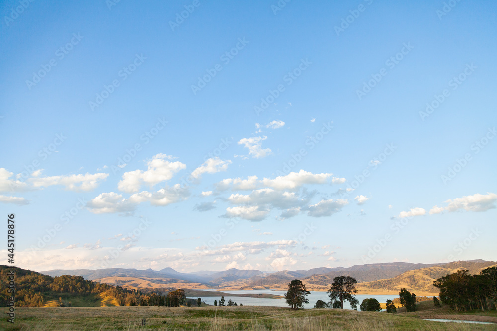 View of paddocks and Lake St Clair in the distance in evening light View of paddocks and Lake St Clair in the distance in evening light