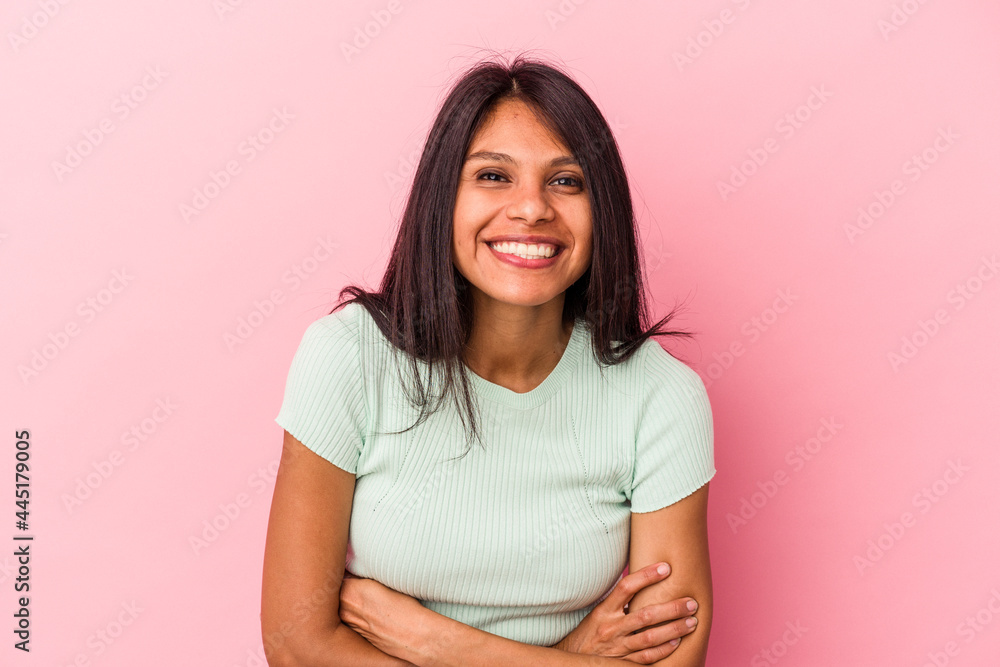 Young latin woman isolated on pink background laughing and having fun. Young latin woman isolated on pink background laughing and having fun.