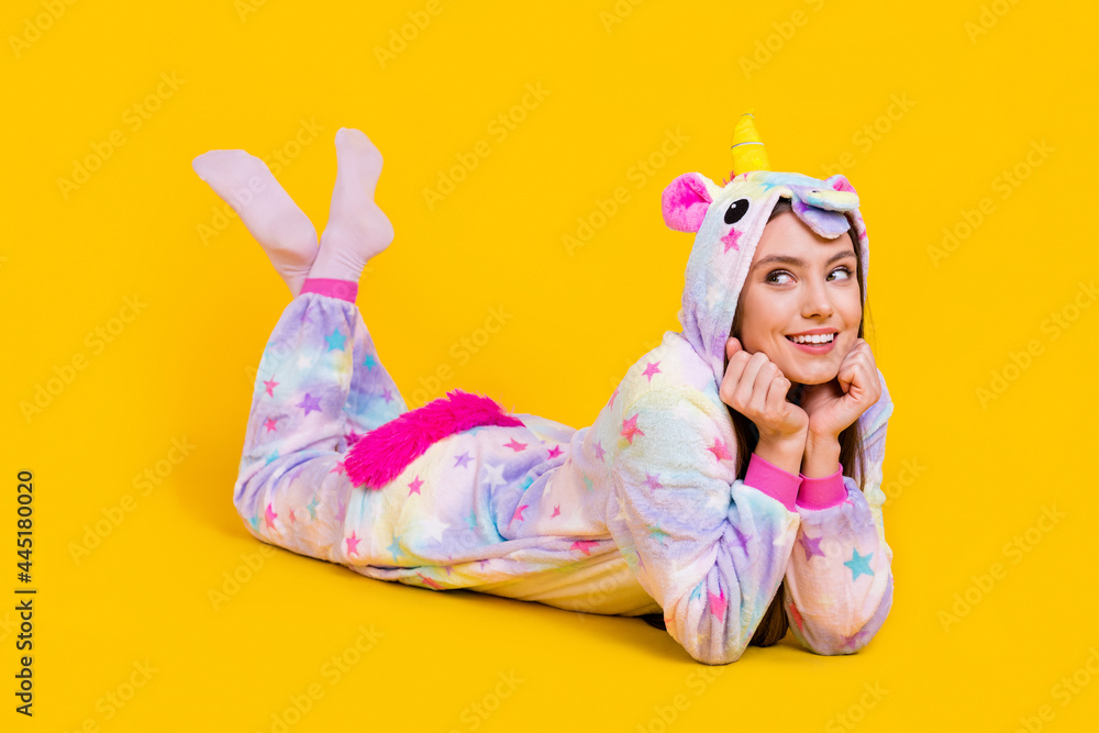 Portrait of attractive cheerful girl wearing funny clothes lying good mood isolated over bright yellow color background Portrait of attractive cheerful girl wearing funny clothes lying good mood isolated over bright yellow color background
