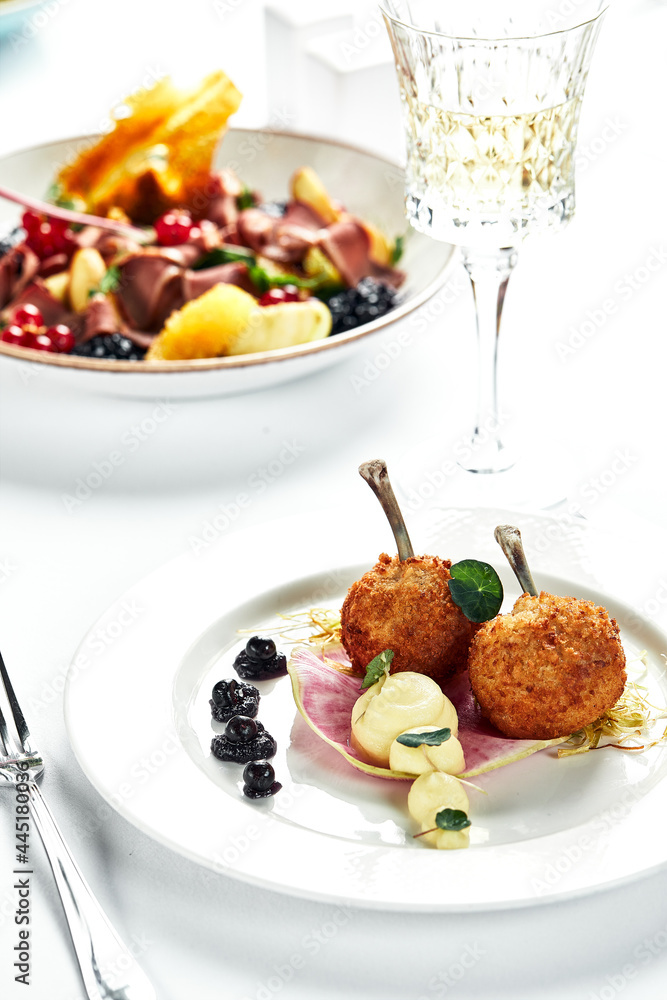 Chicken Kiev on a festive table, light background, white plate, copy space. Chicken Kiev on a festive table, light background, white plate, copy space.
