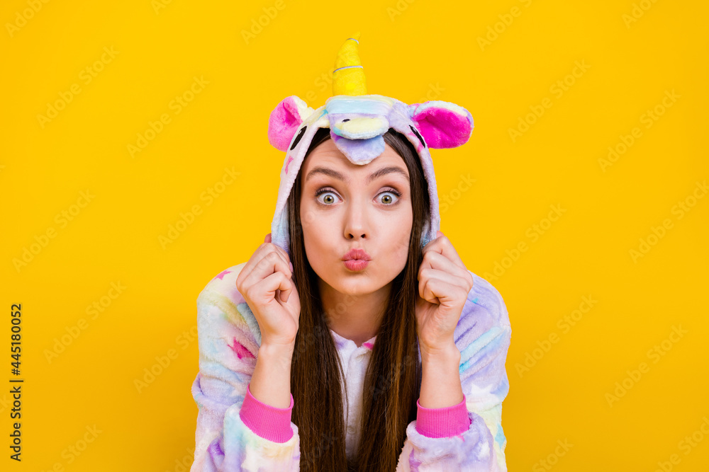 Portrait of attractive funny amazed girl wearing kingurumi sending air kiss isolated over bright yellow color background Portrait of attractive funny amazed girl wearing kingurumi sending air kiss isolated over bright yellow color background