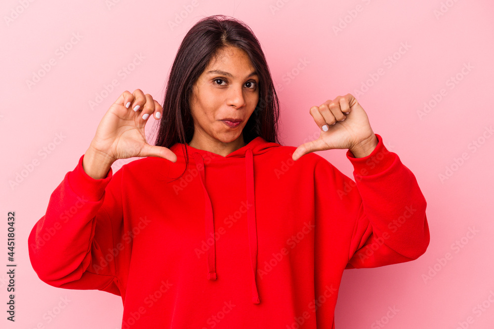 Young latin woman isolated on pink background feels proud and self confident, example to follow. Young latin woman isolated on pink background feels proud and self confident, example to follow.