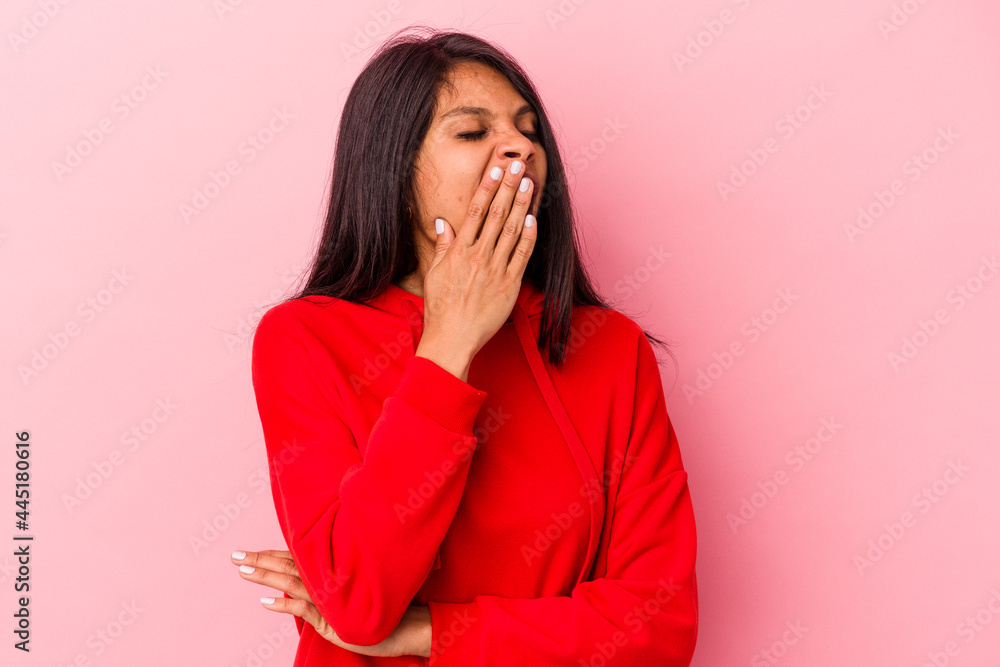 Young latin woman isolated on pink background yawning showing a tired gesture covering mouth with hand. Young latin woman isolated on pink background yawning showing a tired gesture covering mouth with hand.