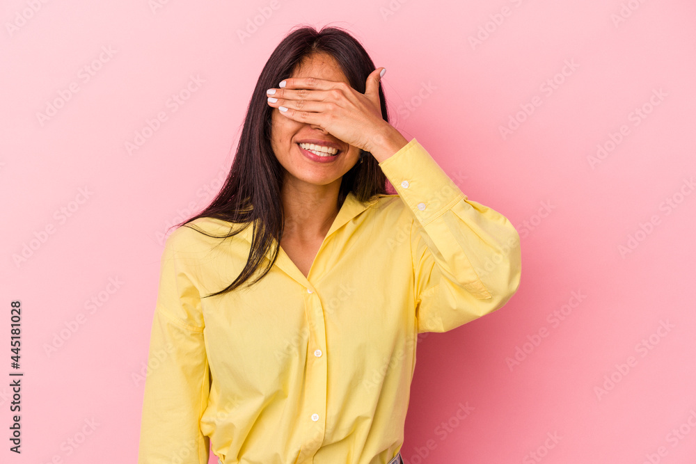Young latin woman isolated on pink background covers eyes with hands, smiles broadly waiting for a surprise. Young latin woman isolated on pink background covers eyes with hands, smiles broadly waiting for a surprise.