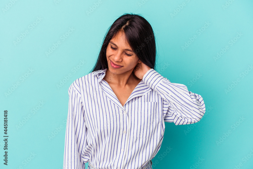 Young latin woman isolated on blue background suffering neck pain due to sedentary lifestyle. Young latin woman isolated on blue background suffering neck pain due to sedentary lifestyle.