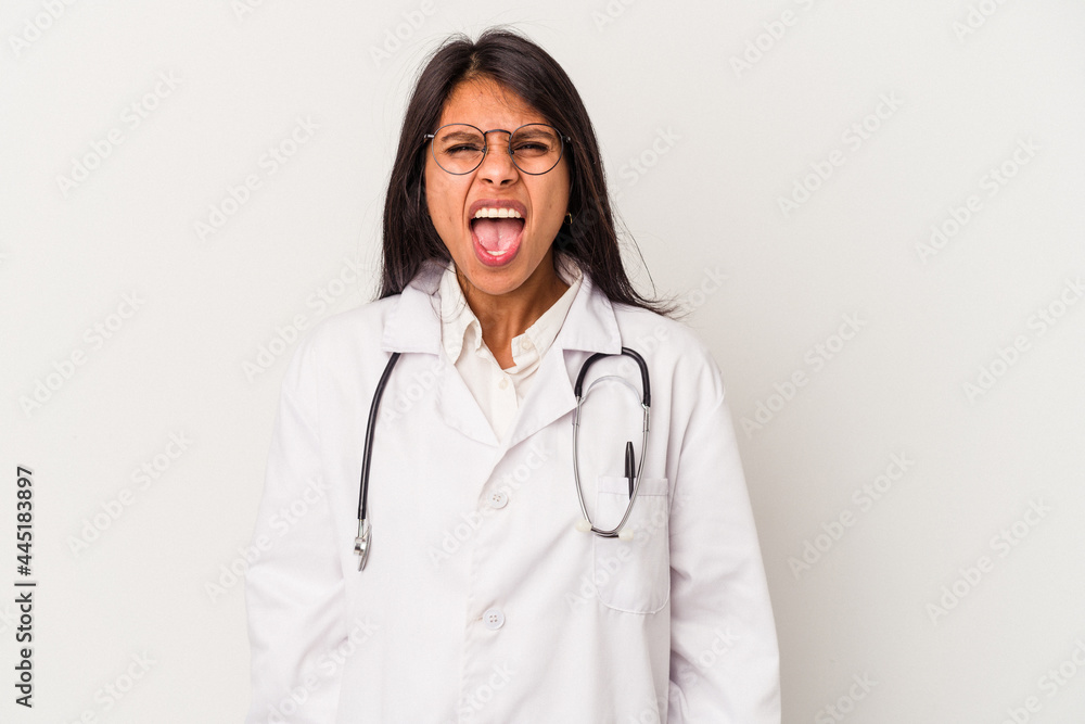 Young doctor latin woman isolated on white background screaming very angry and aggressive. Young doctor latin woman isolated on white background screaming very angry and aggressive.