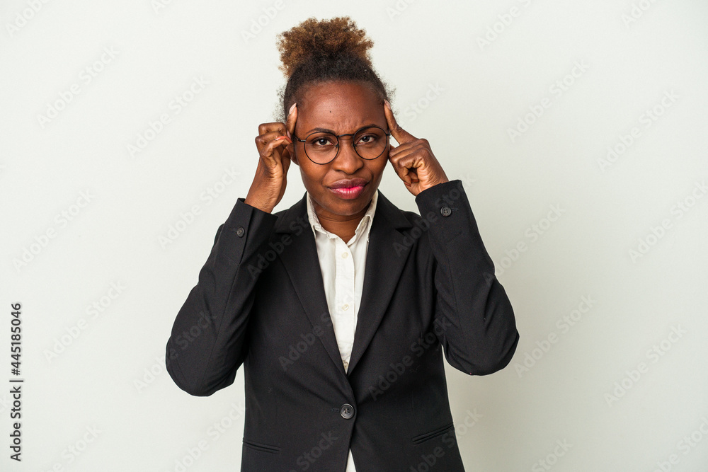Young business african american woman isolated on white background focused on a task, keeping forefingers pointing head. Young business african american woman isolated on white background focused on a task, keeping forefingers pointing head.