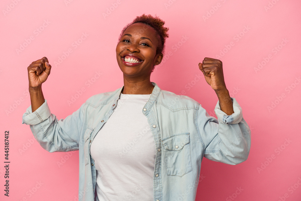 Young african american woman isolated on pink background cheering carefree and excited. Victory concept. Young african american woman isolated on pink background cheering carefree and excited. Victory concept.
