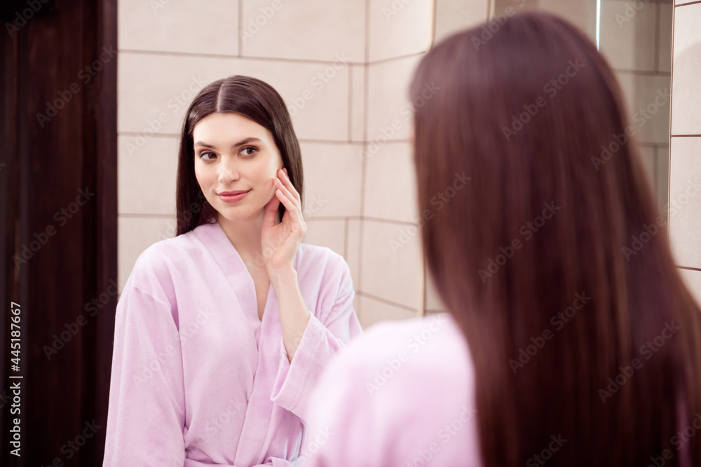 Photo of adorable shiny young lady pink sleepwear looking mirror smiling arm hand cheek cheekbone indoors room home Photo of adorable shiny young lady pink sleepwear looking mirror smiling arm hand cheek cheekbone indoors room home