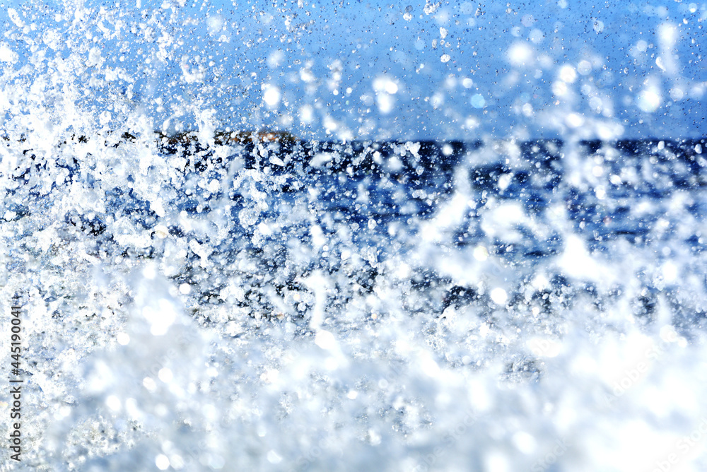 water droplets in the air on a blue sea background, splashes like crystals water droplets in the air on a blue sea background, splashes like crystals