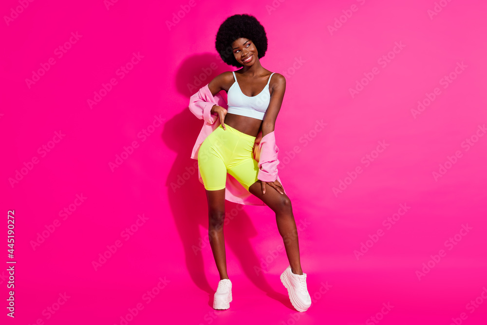 Photo of sweet charming dark skin lady wear casual shirt looking empty space smiling isolated pink color background Photo of sweet charming dark skin lady wear casual shirt looking empty space smiling isolated pink color background