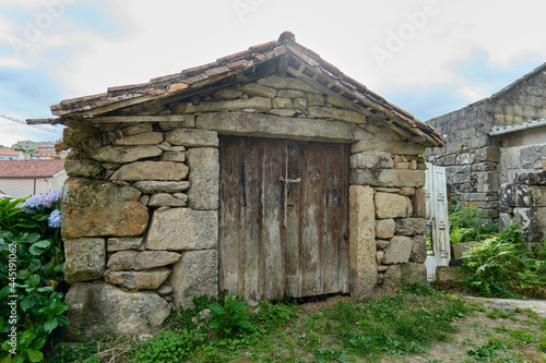 Fototapet abandoned old shed made of stone