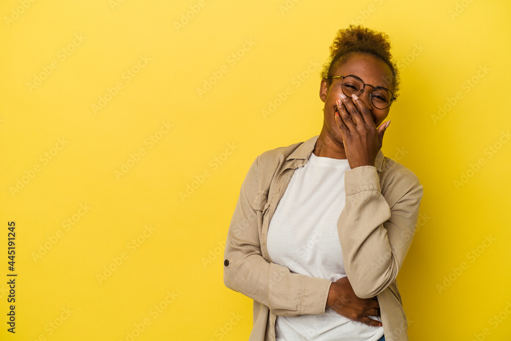 Young african american woman isolated on yellow background laughing happy, carefree, natural emotion. Young african american woman isolated on yellow background laughing happy, carefree, natural emotion.