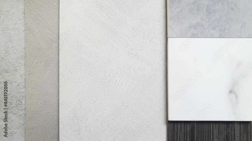 interior material board including stucco concrete laminated palette, white and grey artificial marble stone, italian walnut veneer samples. close up view of mood and tone presentation board. interior material board including stucco concrete laminated palette, white and grey artificial marble stone, italian walnut veneer samples. close up view of mood and tone presentation board.
