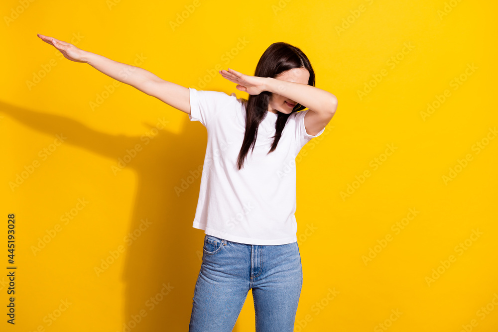 Photo of sweet funny young woman wear white t-shirt dancing showing dab sign isolated yellow color background Photo of sweet funny young woman wear white t-shirt dancing showing dab sign isolated yellow color background