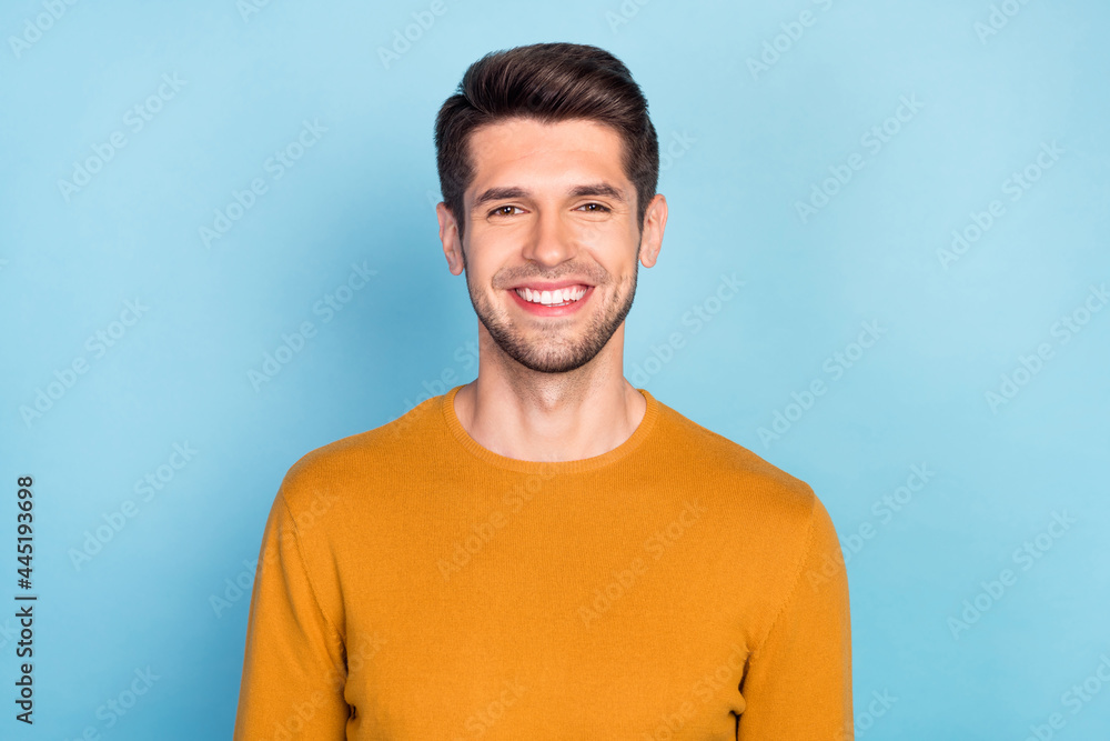 Fototapeta premium Photo of pretty charming young man wear yellow sweater smiling isolated blue color background