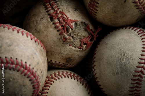 Baseball balls from old used game equipment as group background.