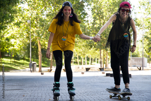 girls skating on the street approaching the camera