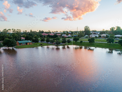 Playing field turned into a peaceful dam with sunset reflections during flood and river backflow