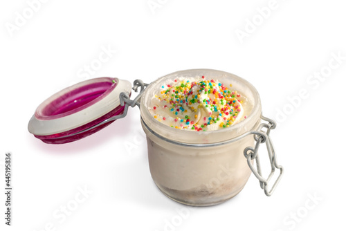 Milk ice cream with colorful sugar beads served in open Glass Jar. Isolated on white