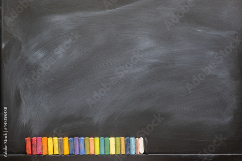 Blackboard with colored chalks