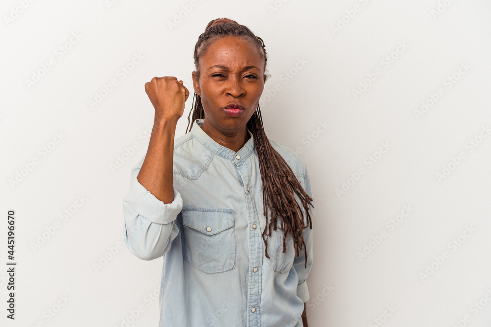 Young african american woman isolated on white background showing fist to camera, aggressive facial expression. Young african american woman isolated on white background showing fist to camera, aggressive facial expression.