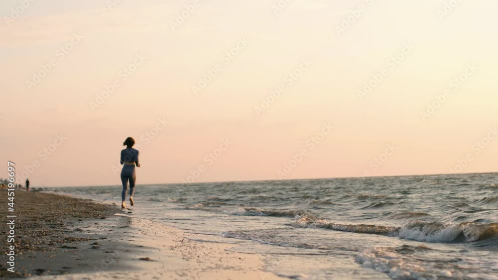 Young caucasian woman are exercising with outdoor running with a sea background. When the sun rise in summer, Concept healthy running and outdoor exercise Young caucasian woman are exercising with outdoor running with a sea background. When the sun rise in summer, Concept healthy running and outdoor exercise