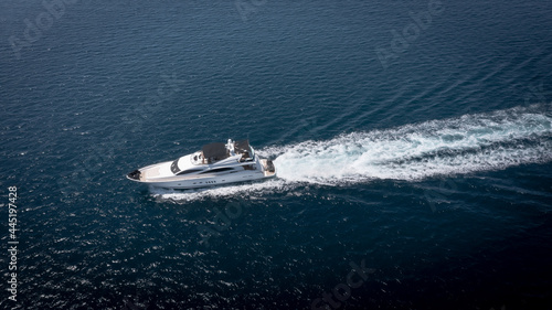 Aerial view of luxury speedboat yacht cruising in deep ocean water. © Jag_cz
