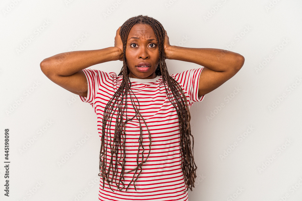 Young african american woman isolated on white background covering ears with hands trying not to hear too loud sound. Young african american woman isolated on white background covering ears with hands trying not to hear too loud sound.