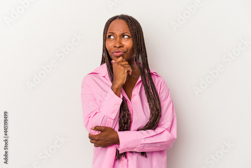 Young african american woman isolated on white background looking sideways with doubtful and skeptical expression.