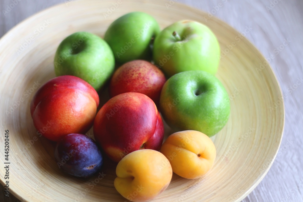 Wooden bowl with various colorful fruit. Selective focus. Wooden bowl with various colorful fruit. Selective focus.