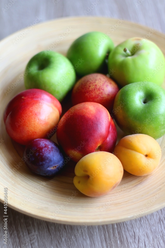 Wooden bowl with various colorful fruit. Selective focus. Wooden bowl with various colorful fruit. Selective focus.