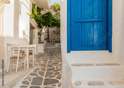 Fototapeta Naklejka Na Ścianę i Meble -  Picturesque mediterranean street with white walls and a blue door
