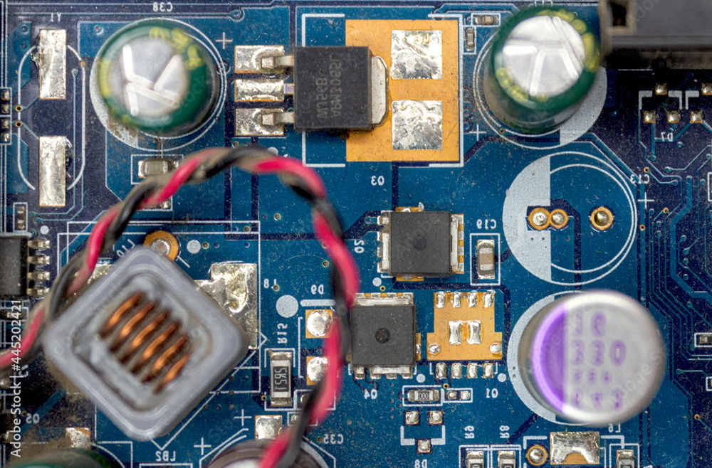 Fototapeta premium A microchip with components in close-up. Processor with resistors, transistors and chip components