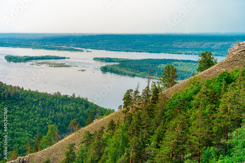 Panorama of mountains with a dense forest and the Volga River on the background, photographed from a height. Nature of Russia