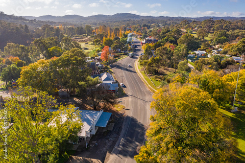 Aerial view of a road curving through a country town in Autumn photo