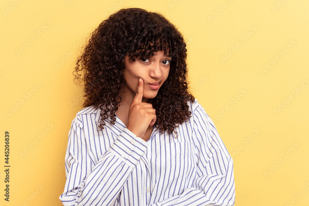 Young mixed race woman isolated on yellow background contemplating, planning a strategy, thinking about the way of a business. Young mixed race woman isolated on yellow background contemplating, planning a strategy, thinking about the way of a business.