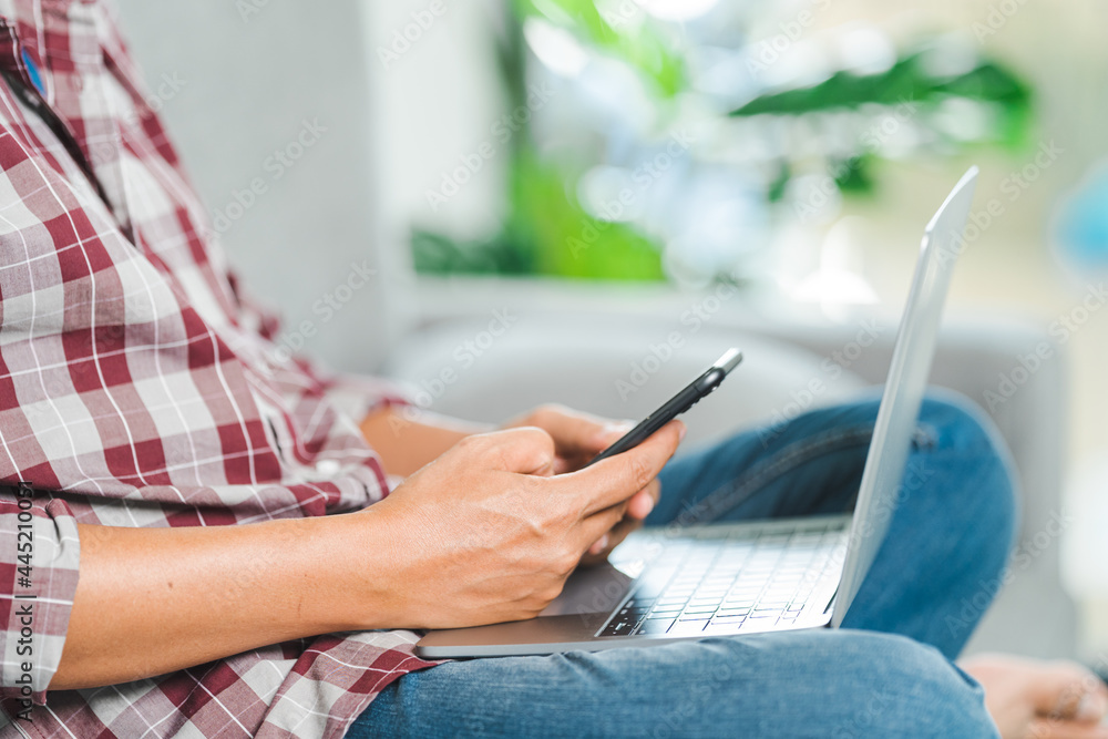 Naklejka premium Cropped close-up image of a businessman`s hands typing working on a laptop at the home office. Freelancer, remote occupation, tutor, student e-learning concept
