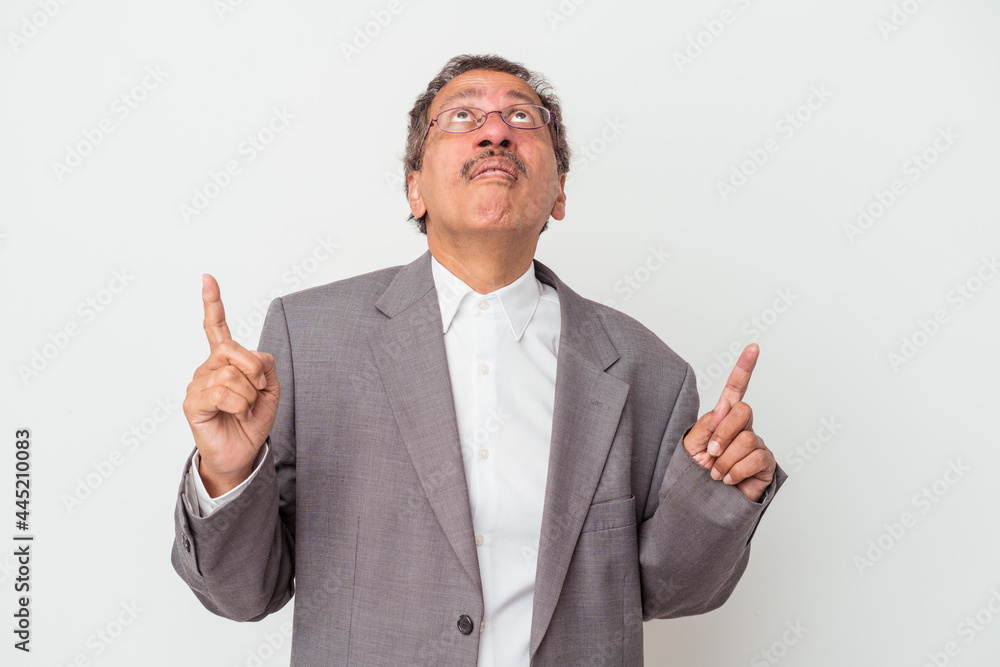 Middle aged indian business man isolated on white background pointing upside with opened mouth. Middle aged indian business man isolated on white background pointing upside with opened mouth.