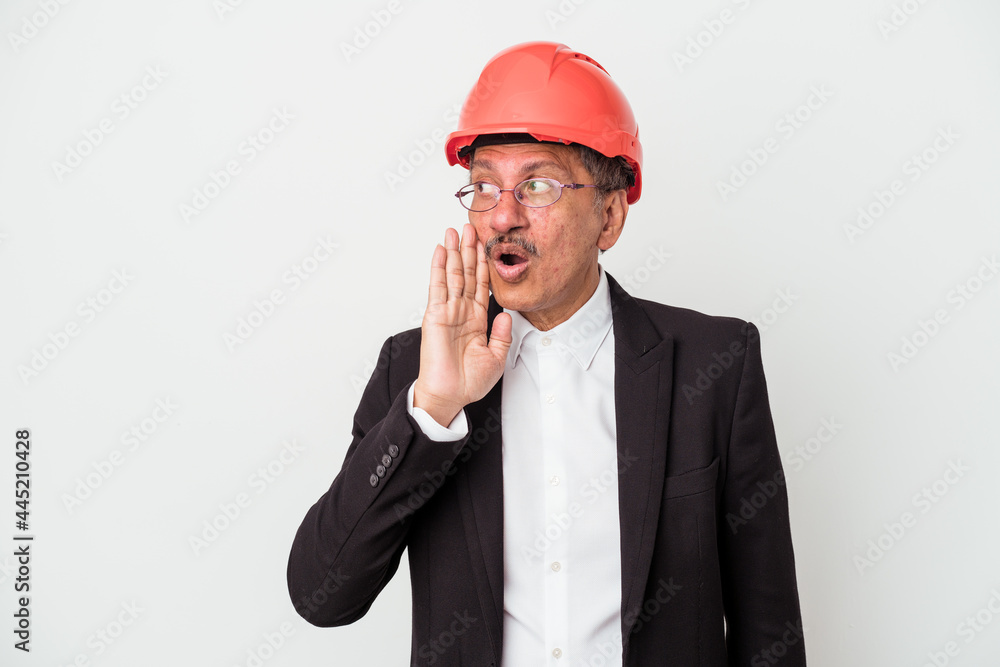 Middle aged indian architect man isolated on white background is saying a secret hot braking news and looking aside Middle aged indian architect man isolated on white background is saying a secret hot braking news and looking aside