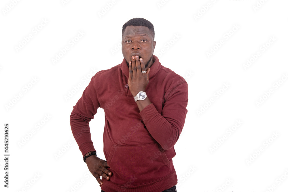 astonished young man covering mouth with hand. astonished young man covering mouth with hand.