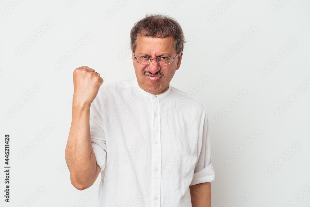 Middle aged indian man isolated on white background showing fist to camera, aggressive facial expression. Middle aged indian man isolated on white background showing fist to camera, aggressive facial expression.