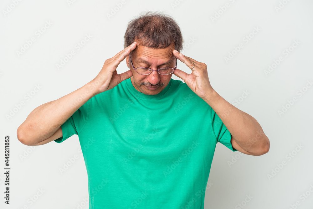 Middle aged indian man isolated on white background touching temples and having headache. Middle aged indian man isolated on white background touching temples and having headache.