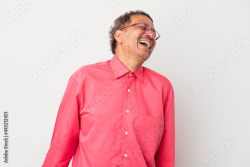 Middle aged indian man isolated on white background dancing and having fun. © Asier