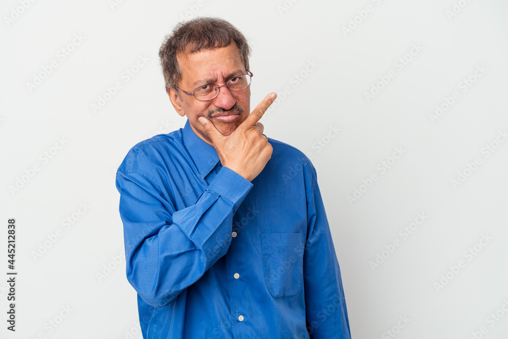 Middle aged indian man isolated on white background contemplating, planning a strategy, thinking about the way of a business. Middle aged indian man isolated on white background contemplating, planning a strategy, thinking about the way of a business.