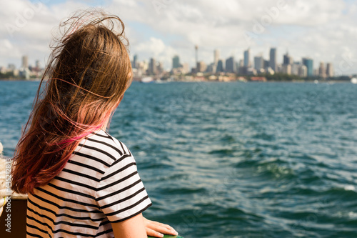 person on ferry looking at Sydney city photo