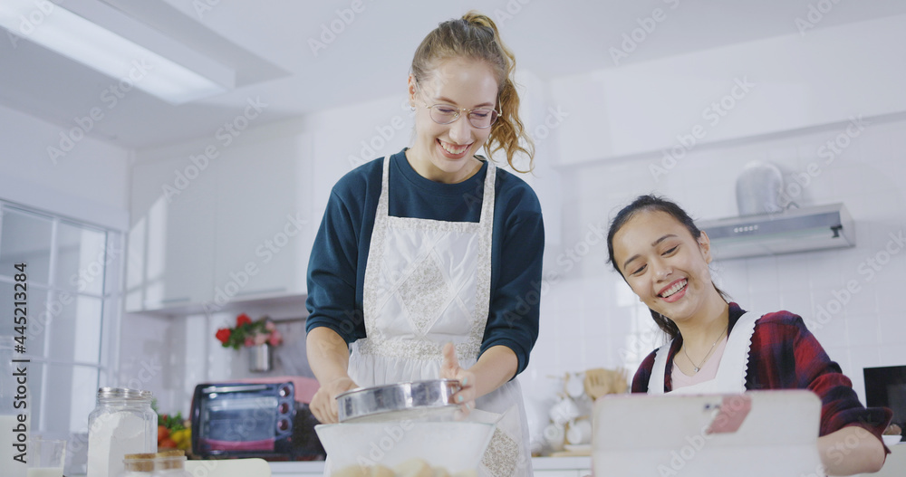 Family Teenage women two of multi ethnic are cooking bread. Bakery in the kitchen at home. Weekend cooking activity for young people. lifestyles concept. Online cooking class that Stay at home. Family Teenage women two of multi ethnic are cooking bread. Bakery in the kitchen at home. Weekend cooking activity for young people. lifestyles concept. Online cooking class that Stay at home.