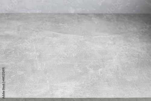 Grey table top and  wall background texture. Front view of tabletop and wall