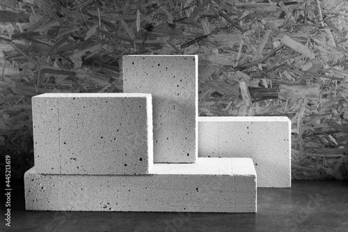 Aerated concrete block cube or bricks near osb wall background texture. Construction concept photo