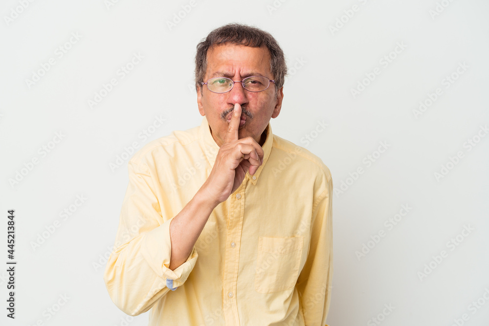 Middle aged indian man isolated on white background keeping a secret or asking for silence. Middle aged indian man isolated on white background keeping a secret or asking for silence.